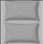 Close-up of tiny multicolored dash and dot specks printed on cream cotton fabric