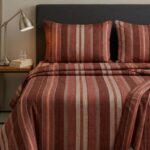 Bedeasia rust striped cotton king size bedsheet on bed with matching pillow covers