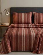 Bedeasia rust striped cotton king size bedsheet on bed with matching pillow covers