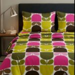 Retro floral printed cotton bedsheet set in yellow pink and green on bed